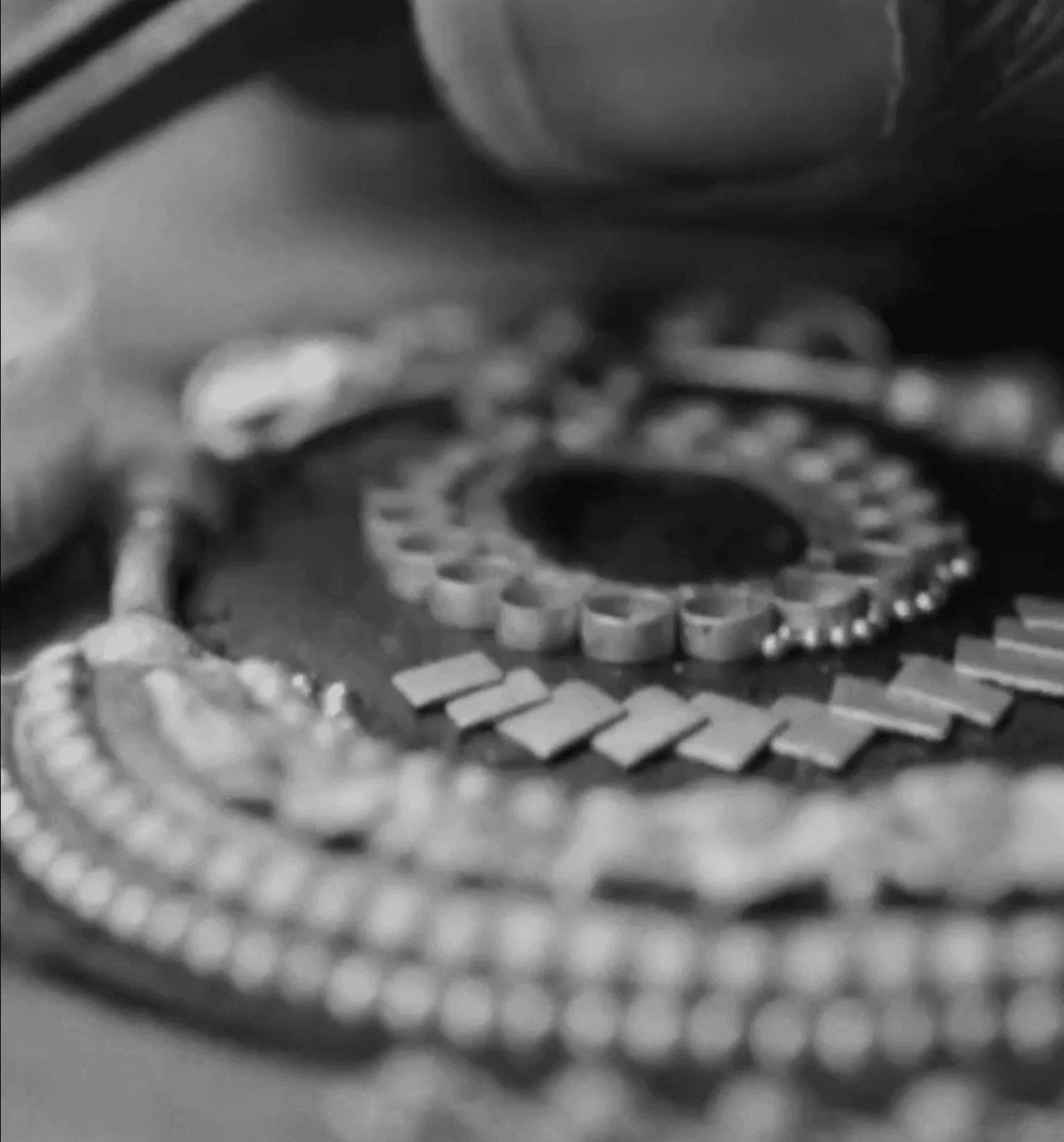 Macro detail of jewelry craftsmanship showing hand-set work and materiality
