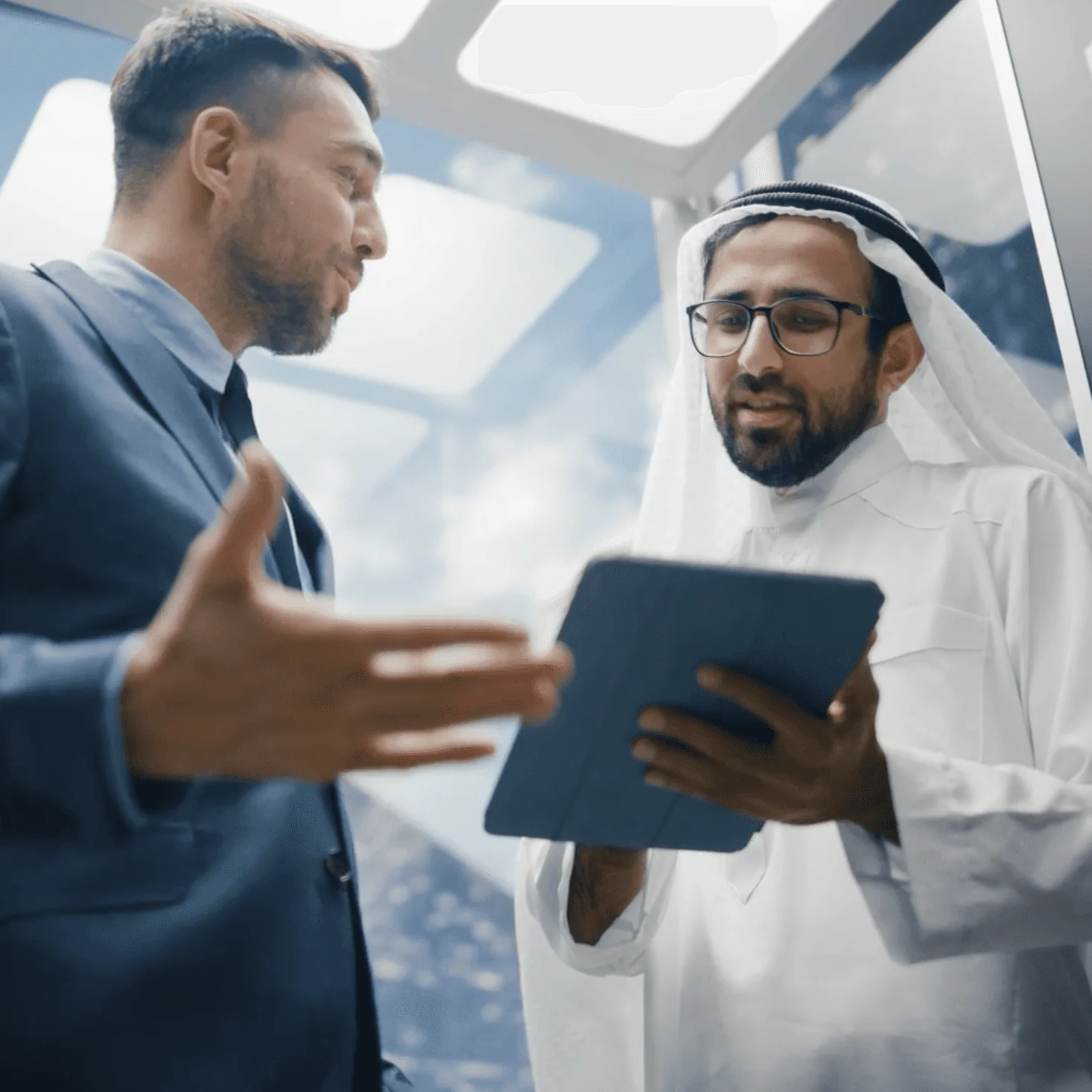 Arab Financial Services executives reviewing fintech strategy on tablet, symbolizing trust and digital agility