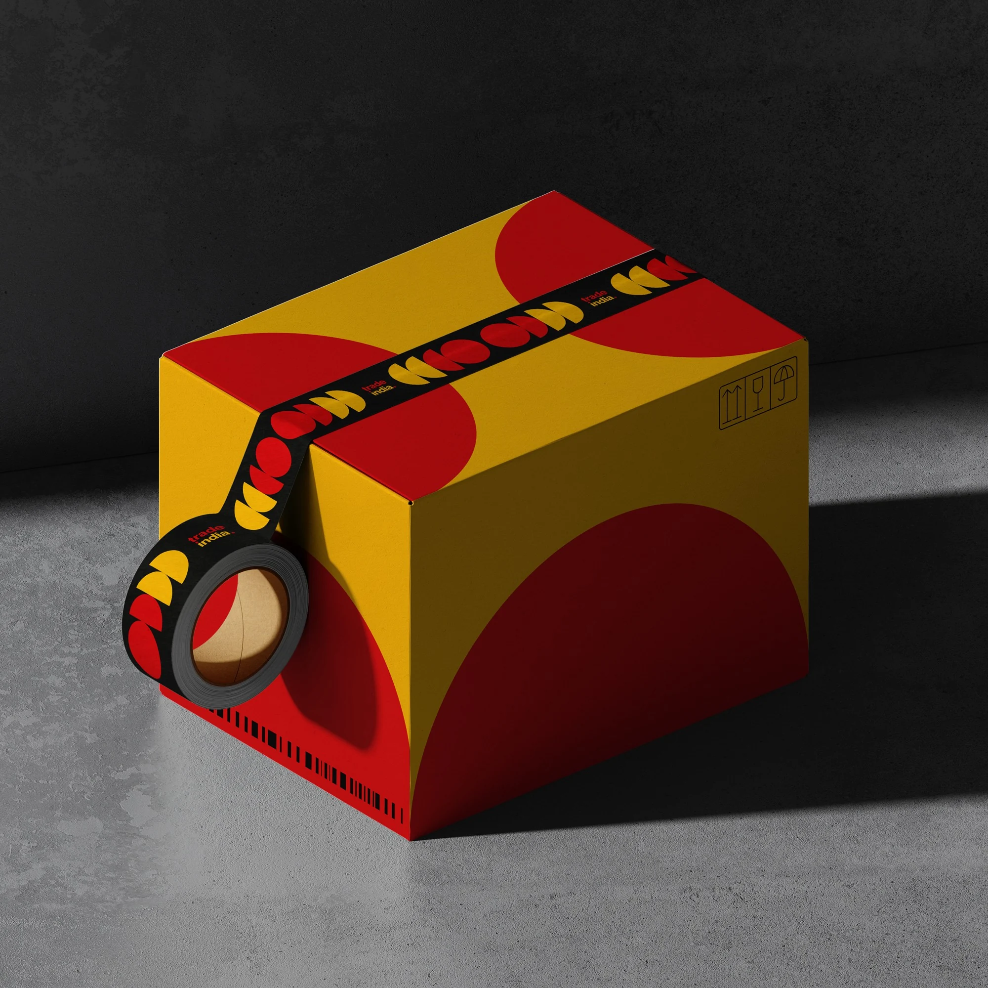 Trade India packaging box and tape showing high-energy colour blocks and repeating wordmark pattern