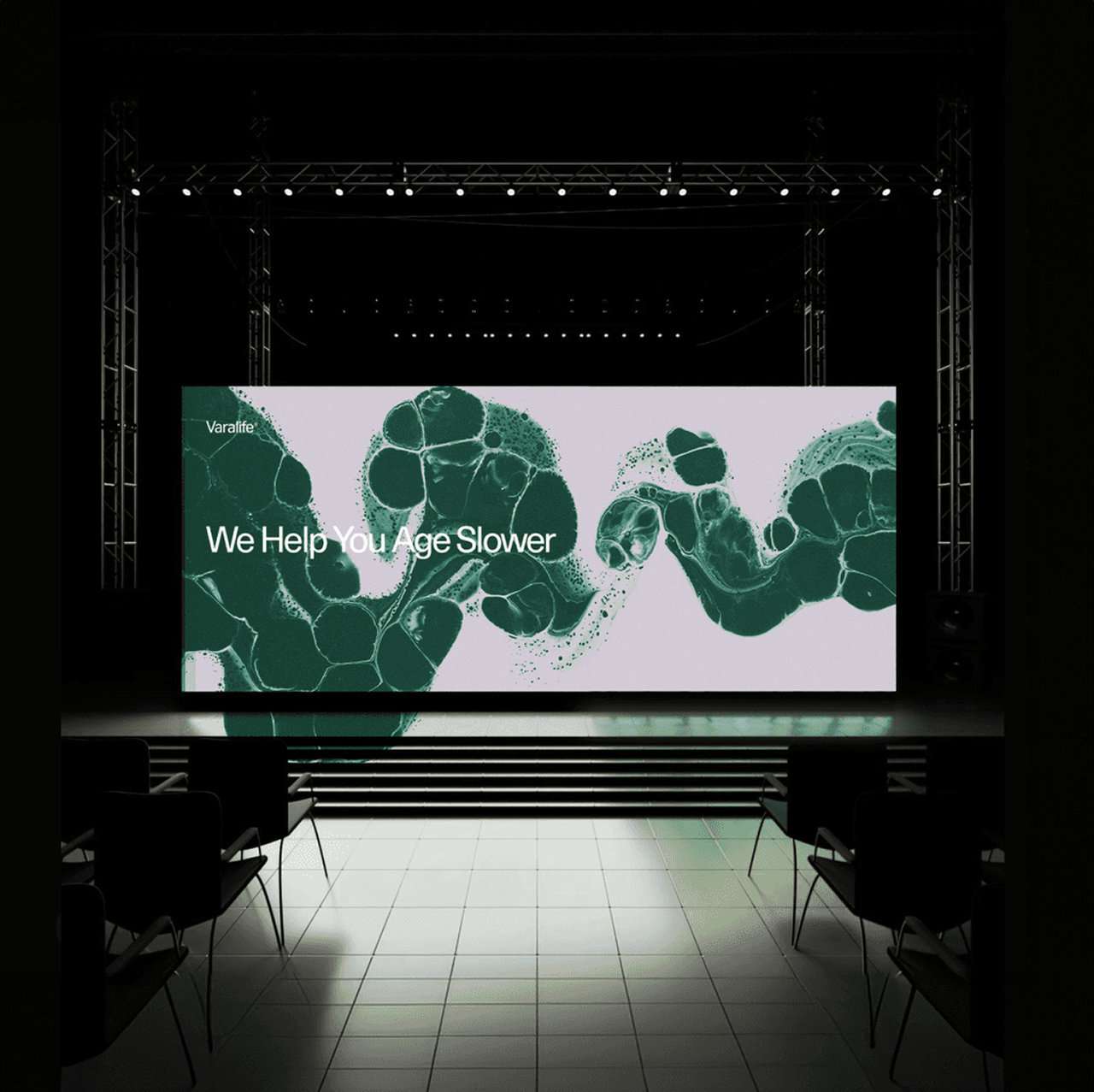 Varalife identity and green cell imagery on an event stage